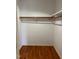 Large walk-in closet with wood shelving and rod at 6232 Dawn Dr, Hurdle Mills, NC 27541