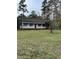 House exterior showcasing a spacious yard and covered porch at 6232 Dawn Dr, Hurdle Mills, NC 27541