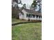 Side view of the house, highlighting its brick facade and landscaping at 6232 Dawn Dr, Hurdle Mills, NC 27541