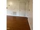 Spacious room with hardwood floors and a door leading to another room at 6232 Dawn Dr, Hurdle Mills, NC 27541