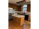 Kitchen with wood cabinets, island, and stainless steel appliances at 6232 Dawn Dr, Hurdle Mills, NC 27541