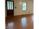 Living room featuring hardwood floors and a wooden door at 6232 Dawn Dr, Hurdle Mills, NC 27541