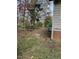 Side yard with a partially visible shed and trees at 6232 Dawn Dr, Hurdle Mills, NC 27541
