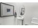 Clean powder room with pedestal sink, toilet, and oval mirror at 6440 Alfalfa Ln, Wake Forest, NC 27587