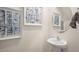 Stylish powder room with pedestal sink and framed art at 8658 Brixton Shay Dr, Raleigh, NC 27616