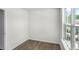 Spacious bedroom with wood-look flooring and a large window at 8658 Brixton Shay Dr, Raleigh, NC 27616