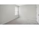Spacious bedroom with neutral carpeting and window at 8658 Brixton Shay Dr, Raleigh, NC 27616