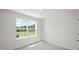 Well-lit bedroom with a large window offering a view of the outdoors at 8658 Brixton Shay Dr, Raleigh, NC 27616