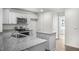 Modern kitchen with granite countertops and an island at 8658 Brixton Shay Dr, Raleigh, NC 27616