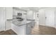Modern kitchen with island, granite countertops, and stainless steel appliances at 8658 Brixton Shay Dr, Raleigh, NC 27616