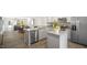 Open concept kitchen with island, stainless steel appliances, and hardwood floors at 8658 Brixton Shay Dr, Raleigh, NC 27616