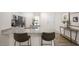 Open kitchen features a granite island with seating and stainless steel appliances at 8658 Brixton Shay Dr, Raleigh, NC 27616