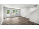 Bright living room with hardwood floors and large windows at 8658 Brixton Shay Dr, Raleigh, NC 27616