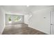 Open living room with wood-look floors and access to patio at 8658 Brixton Shay Dr, Raleigh, NC 27616