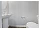 Simple powder room with pedestal sink and toilet at 901 Arnold Place Dr, Fuquay Varina, NC 27526