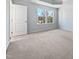 Bright bedroom with neutral carpeting and large windows at 901 Arnold Place Dr, Fuquay Varina, NC 27526