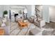 Virtually staged living room with neutral colored furniture and a large area rug at 901 Arnold Place Dr, Fuquay Varina, NC 27526
