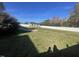 Private backyard with shed, patio, and a large grassy area at 115 Hunterwood Pl, Benson, NC 27504