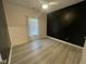 Spacious bedroom with a black accent wall and laminate flooring at 115 Hunterwood Pl, Benson, NC 27504