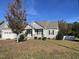Gray sided ranch home with stone accents and landscaping at 115 Hunterwood Pl, Benson, NC 27504