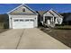 Gray sided ranch home with a two car garage and landscaping at 115 Hunterwood Pl, Benson, NC 27504