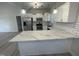 Modern kitchen with white cabinets, marble counters, and stainless steel appliances at 115 Hunterwood Pl, Benson, NC 27504