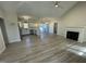Open living room and kitchen with LVP flooring and fireplace at 115 Hunterwood Pl, Benson, NC 27504