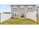Back exterior view, gray siding, and small fenced yard at 1823 Hinesley Dr, Durham, NC 27703