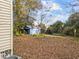 Backyard with detached blue shed and fall leaves at 307 Bickett Blvd, Raleigh, NC 27608