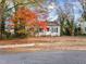 Cozy yellow house with red door and fall leaves at 307 Bickett Blvd, Raleigh, NC 27608