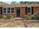 Brick ranch house with a covered carport and landscaped yard at 308 Santee Rd, Durham, NC 27704