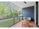 Private balcony with wooden deck, metal railings, and backyard view at 511 S Bloodworth St # 103, Raleigh, NC 27601
