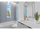 Modern bathroom with blue tile, a bathtub, and a floating vanity at 511 S Bloodworth St # 103, Raleigh, NC 27601