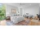 Spacious bedroom with large windows, hardwood floors, and two armchairs at 511 S Bloodworth St # 103, Raleigh, NC 27601