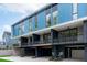 Modern building exterior with blue siding, private balconies and attached garages at 511 S Bloodworth St # 103, Raleigh, NC 27601