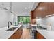 Modern kitchen with marble countertops and wood cabinets at 511 S Bloodworth St # 103, Raleigh, NC 27601