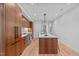 Modern kitchen with wood cabinets and island, hardwood floors at 511 S Bloodworth St # 103, Raleigh, NC 27601