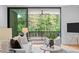 Spacious living area with large windows offering scenic views and access to a balcony at 511 S Bloodworth St # 103, Raleigh, NC 27601
