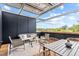 Relaxing rooftop deck features a seating area and dining space, perfect for outdoor entertaining at 511 S Bloodworth St # 103, Raleigh, NC 27601