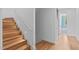 Modern light wood staircase with a white railing and recessed lighting at 511 S Bloodworth St # 103, Raleigh, NC 27601