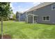 Spacious backyard with grassy lawn and a screened porch at 516 Lemon Daisy Ln, Knightdale, NC 27545