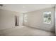 Well-lit bedroom with carpeted floors and access to a bathroom at 516 Lemon Daisy Ln, Knightdale, NC 27545
