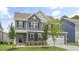 Two-story home with gray siding, white trim, and a two-car garage at 516 Lemon Daisy Ln, Knightdale, NC 27545