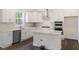 Modern kitchen with white cabinets, quartz countertops, and stainless steel appliances at 516 Lemon Daisy Ln, Knightdale, NC 27545