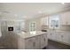Open concept kitchen with island and views into the living room at 516 Lemon Daisy Ln, Knightdale, NC 27545