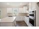 Modern kitchen with white cabinets, quartz countertops, and stainless steel appliances at 516 Lemon Daisy Ln, Knightdale, NC 27545
