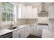 Modern kitchen with white cabinets, quartz countertops, and stainless steel appliances at 516 Lemon Daisy Ln, Knightdale, NC 27545