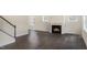 Bright living room featuring hardwood floors and a fireplace at 516 Lemon Daisy Ln, Knightdale, NC 27545