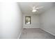 Bedroom with gray carpeting, white walls, and a ceiling fan at 667 Bashford Rd, Raleigh, NC 27606