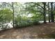 View of the yard with trees, shrubs and a street at 667 Bashford Rd, Raleigh, NC 27606